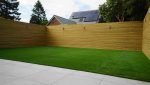 Close-up of artificial grass edge detail next to patio in a Fulwood garden installation
