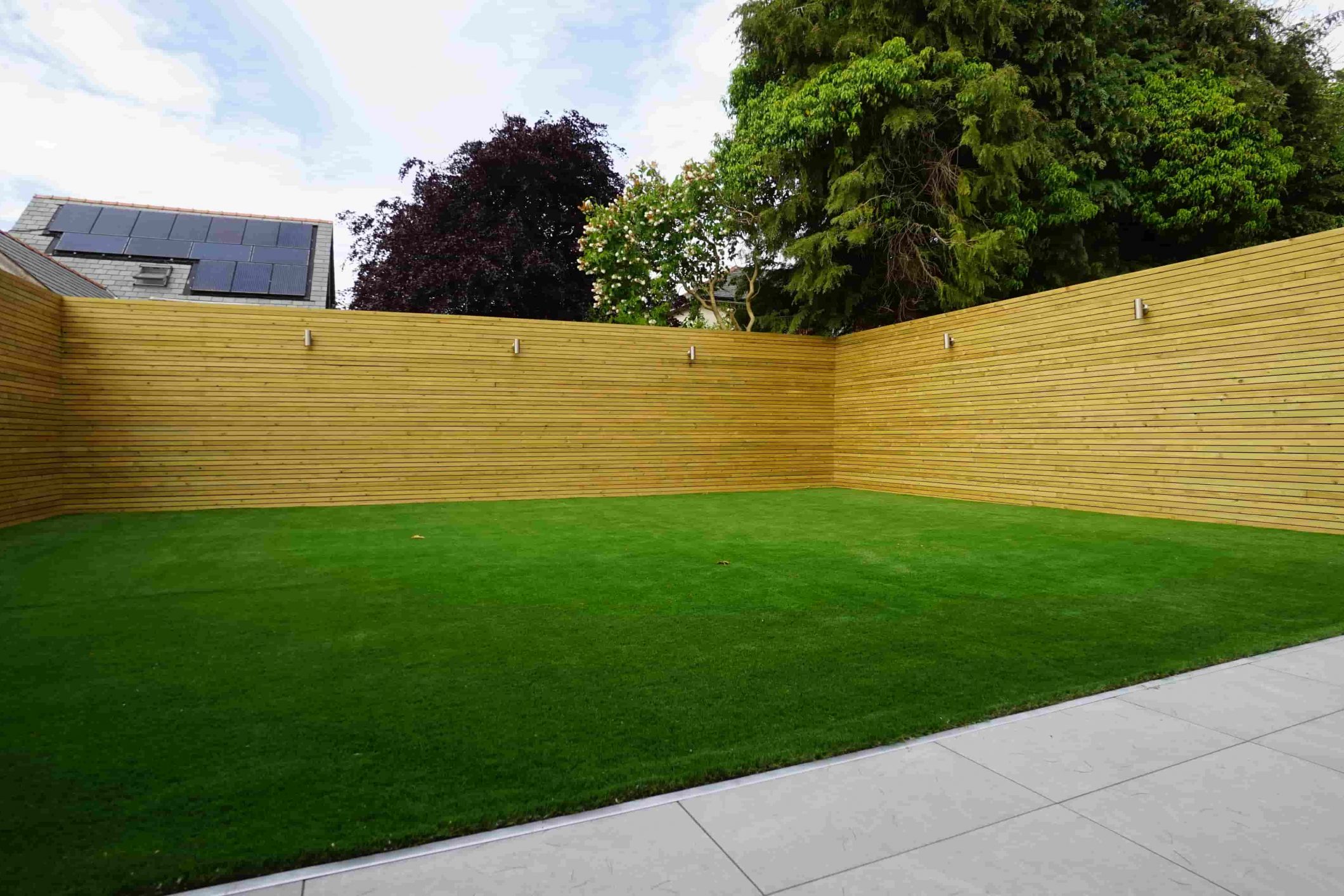 Artificial grass garden installation in Fulwood, Preston with timber fencing and porcelain patio