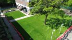 Aerial view of artificial grass laid around trees in a Didsbury school outdoor area