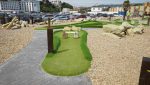Wide view of the newly installed mini golf course featuring high-quality synthetic grass.