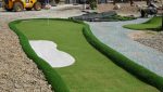 Mini golf obstacles sitting on fresh artificial turf at the Folkestone attraction.