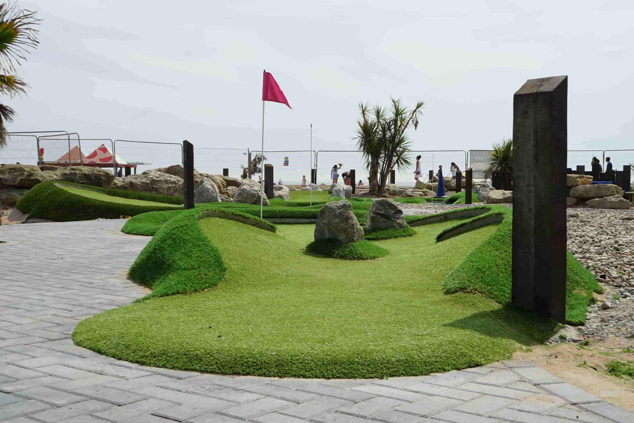 Artificial turf mini golf area with curved shaping and vibrant green fibres.
