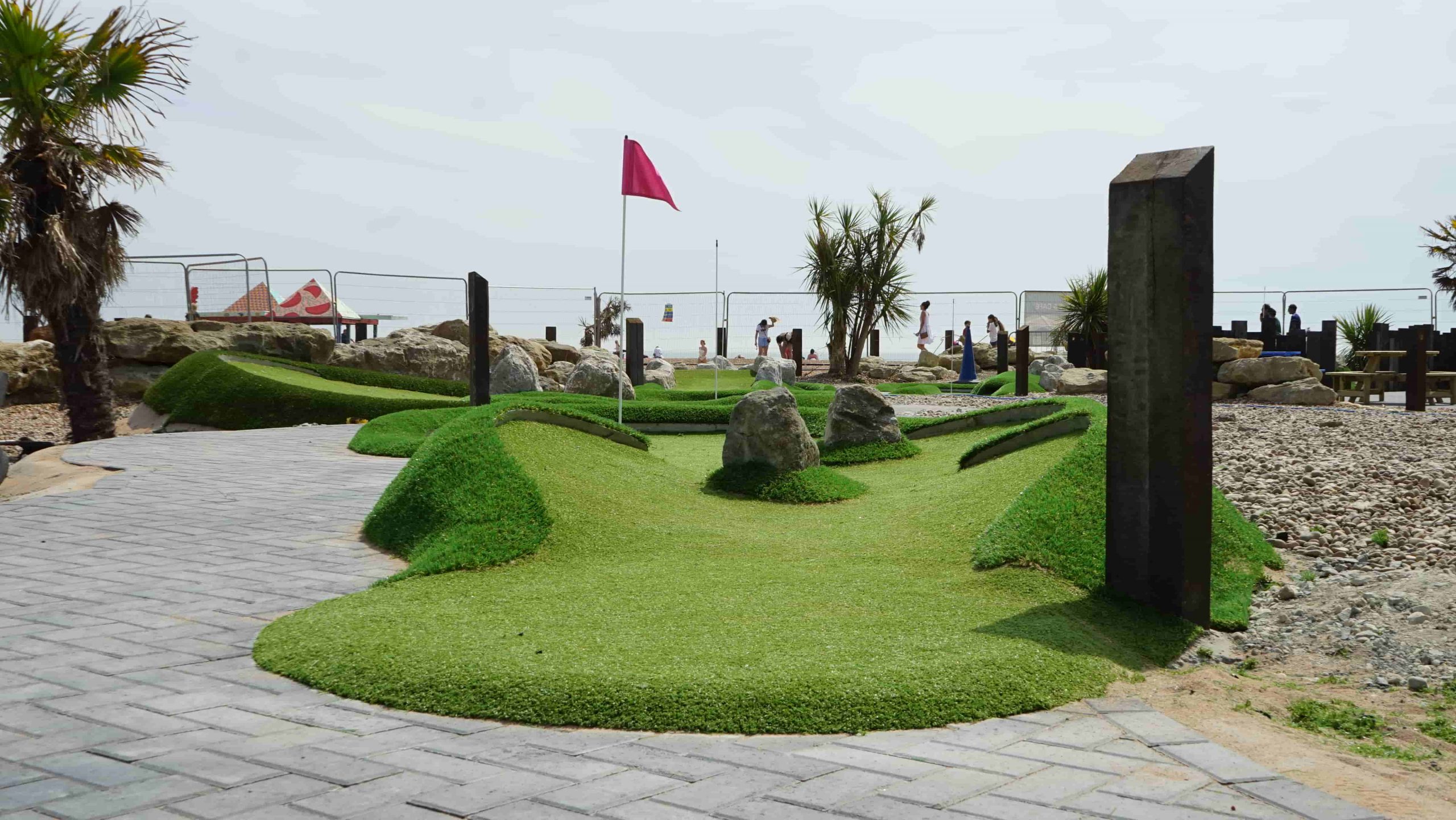 Finished mini golf hole at Folkestone with artificial turf shaped around mounds, paving and course features