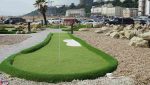 Walkway section of the mini golf course featuring seamless artificial grass installation.