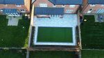 Artificial grass lawn framed by porcelain tiles in a luxury Fulwood garden installation